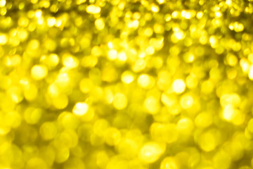 Golden glitter festive background with bokeh lights. Celebration concept for New Year, Christmas Holidays.