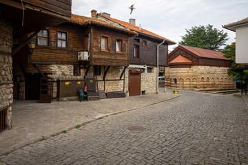 Street of old town. Church of Saint Paraskevi of Iconium (also known as Paraskeva Pyatnitsa) in the background. Nessebar. Bulgaria.