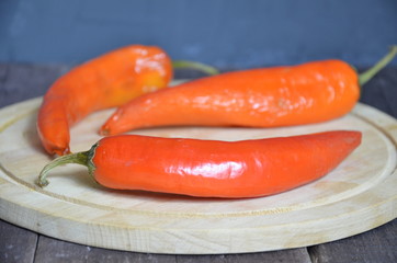 red hot chili pepper corns and pods on dark vintage background, top view