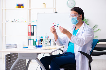 Young male chemist working in the lab