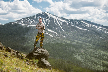 Tourist man photographer taking photos and enjoy the view of mountains in Yellowstone National Park