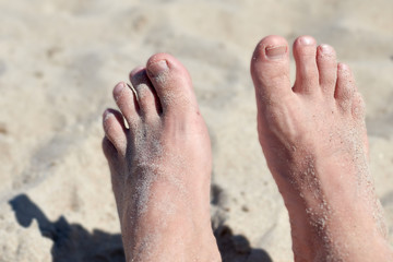 a pair of feet in the sand