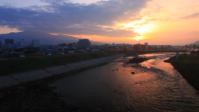 Bessho Line train crossing iron bridge on Chikuma River,  Japan