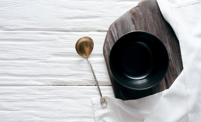 Empty plate with a copy space for food on a white aged wooden kicthen table background.