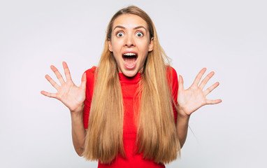 It's amazing. Close up portrait of excited and happy blonde young woman who shouting on camera.