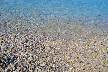 Abstract beach background texture with pebbles, sands and sea water in bodrum turkey