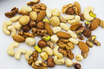 a variety of different kinds of useful nuts on a white background