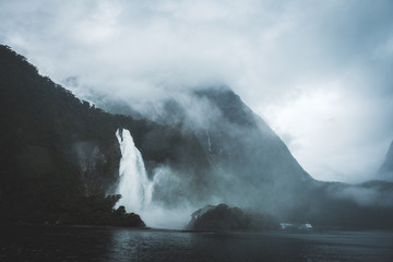 mountain with waterfall in the sea film look milford sounds newzealand
