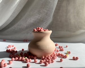 Decorative clay pot with colored dragees.