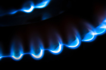 Close up of a natural gas burner on black background