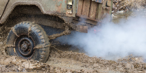 Rally on Russian SUVs in the mud in winter, Trapped all-terrain vehicle pulled out of the river	