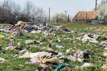 Plastic bags and bottles in a landfill. Unauthorized release of garbage, pollution of nature. The...