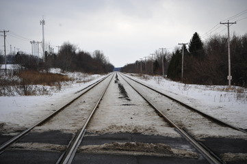 Fototapeta premium Railroad, railway in winter. Path, choice and decision making. Destiny, future and journey meaning