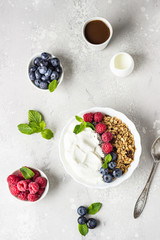 Natural greek yogurt, homemade granola and fresh berries (blueberries and raspberries). 