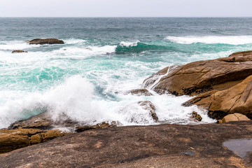Muxia or Mugia rocky coastal view with rough sea on the Way of St. James, Camino de Santiago, Province of A Coruna, Galicia, Spain