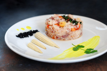 Candles from fresh fish on a plate with corn