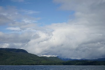 Naklejka na ściany i meble Alaskan Coastline with Mountains and Clouds