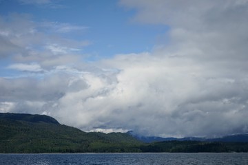 Naklejka na ściany i meble Alaskan Coastline with Mountains and Clouds