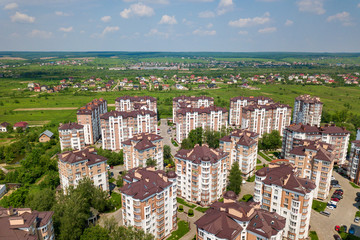 Top view of apartment or office tall buildings, parked cars, urban city landscape. Drone aerial...