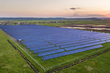 Blue solar photo voltaic panels system producing renewable clean energy on rural landscape and...
