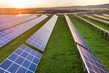 Blue solar photo voltaic panels system producing renewable clean energy on rural landscape and...