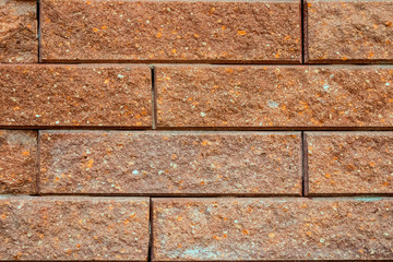 Stone wall made of brown brick.