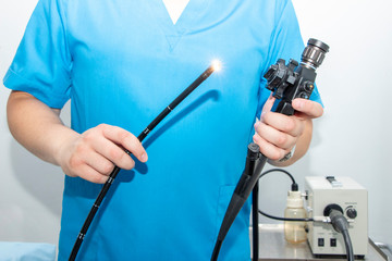 Endoscopy at the hospital. Doctor holding endoscope before gastroscopy. Instrument for endoscopy in the doctor's hands.