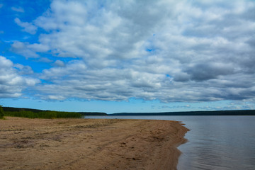 Yellow sandy shore near a large lake