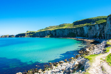 Carrick a Rede Rope Bridge in Ballintoy, Northern Ireland. Beautiful Landscape on Coast of Atlantic Ocean, Clear blue and green water 