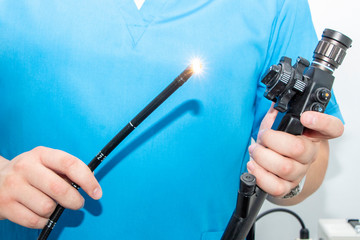 Endoscopy at the hospital. Doctor holding endoscope before gastroscopy. Instrument for endoscopy in...