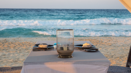 Marsa Matruh, Egypt. Gazebo on the beach with table set. Candle on table. Relaxing context. Nobody on the beach. Blue sea on the back. Fabulous holidays. Mediterranean Sea north Africa