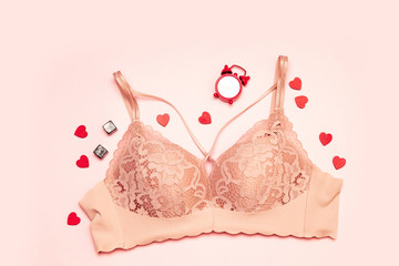 Set of glamorous stylish sexy lace lingerie with women's accessories on a pink background