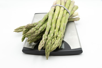 Bunch of asparagus on weighing scale ready for a healthy meal