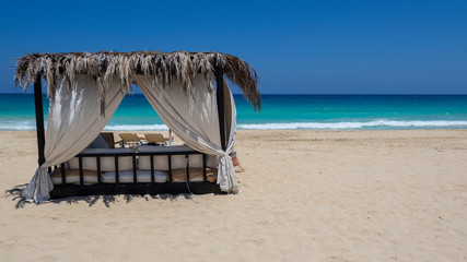 Marsa Matruh, Egypt. Elegant gazebo on the beach. Amazing sea with tropical blue, turquoise and green colors. Relaxing context. Nobody on the beach. Fabulous holidays. Mediterranean Sea. North Africa