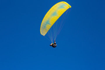 paraglider flying in the blue sky. Paragliding