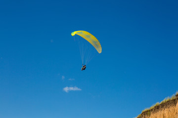 paraglider flying in the blue sky. Paragliding