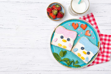 Penguin toasts with colored spread on a plate, food for kids idea