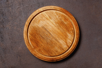 Brown textured background with empty pizza board