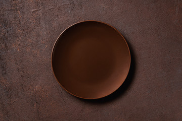 Brown textured background with empty plate