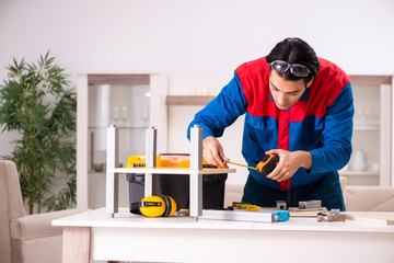 Young contractor repairing furniture at home