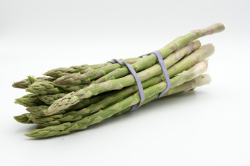 Asparagus surrounded by a medical tape on weighing scale for diets