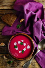 Beet soup with cream and parsley leaves