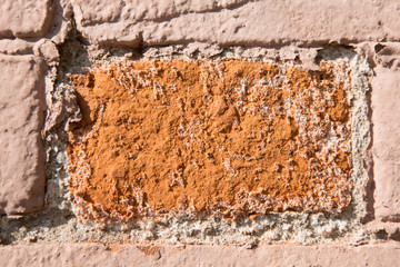 Close-up old red brick wall c. Texture. The bricks are covered with paint that has partially peeled of