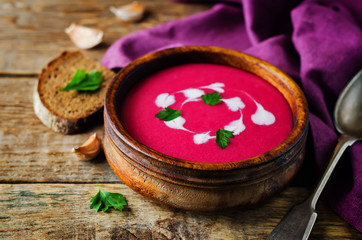 Beet soup with cream and parsley leaves