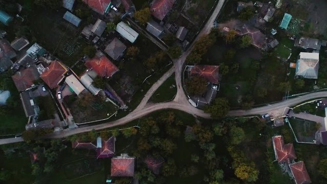 A part of a moldavian village filmed with a drone which is moving perpendicularly upwards.