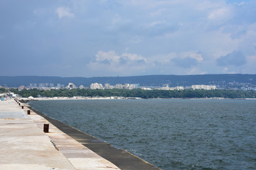 View to the town of Varna from Varna harbour breakwater in a cloudy summer day