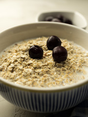 Close up of  porridge with milk and cherries