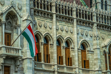 National flag of Hungary on the facade of the Hungarian parliament building	