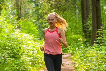 young woman jogging in the forest