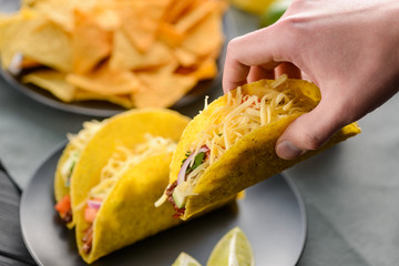 Hand grabbing a taco shell